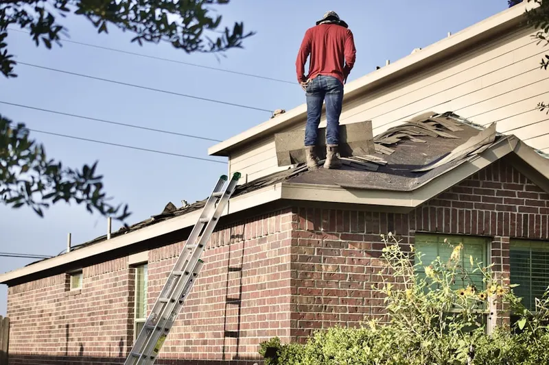 Professional roofer working on a residential roof in Tulare